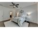 Bright bedroom with ceiling fan, decorative wall art, and an ensuite bathroom at 5650 Bergeson Ways, Cumming, GA 30028