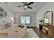 Bright bedroom with a ceiling fan, decorative wall art, and dark hardwood floors at 5650 Bergeson Ways, Cumming, GA 30028