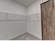 Walk-in closet with wire shelving, neutral paint, and gray carpet at 5650 Bergeson Ways, Cumming, GA 30028