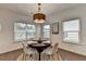 Bright dining area with a round table, stylish chairs, a modern light fixture and natural light at 5650 Bergeson Ways, Cumming, GA 30028