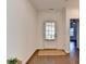 Bright entryway with wood floors, a glass-paneled door, and neutral decor at 5650 Bergeson Ways, Cumming, GA 30028