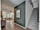 Staircase alongside a dark accent wall in a well-lit entryway with hardwood floors at 5650 Bergeson Ways, Cumming, GA 30028