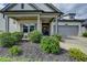 Charming home with a landscaped front yard, neutral brick, and a gray garage door at 5650 Bergeson Ways, Cumming, GA 30028