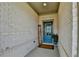 Charming front entry with a bright blue door, 'welcome' sign, and potted plants at 5650 Bergeson Ways, Cumming, GA 30028