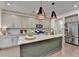 Well-equipped kitchen with granite counters, stainless appliances, a large island, and ample cabinet space at 5650 Bergeson Ways, Cumming, GA 30028