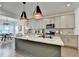 Modern kitchen featuring granite countertops, an island, and stainless steel appliances with a dining area at 5650 Bergeson Ways, Cumming, GA 30028