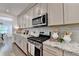Bright kitchen featuring stainless steel appliances, granite countertops, and light wood cabinets at 5650 Bergeson Ways, Cumming, GA 30028