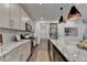 Modern kitchen with granite countertops, stainless steel appliances, and a large island with seating at 5650 Bergeson Ways, Cumming, GA 30028