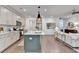 Bright, open kitchen with island, stainless steel appliances, connecting to living room for easy living at 5650 Bergeson Ways, Cumming, GA 30028