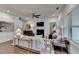 Bright living room with fireplace and view to hall, featuring modern decor and hardwood floors at 5650 Bergeson Ways, Cumming, GA 30028