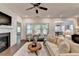 Cozy living room with a fireplace, neutral furniture, and plenty of natural light at 5650 Bergeson Ways, Cumming, GA 30028