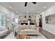 Open-concept living area connecting to the kitchen, featuring modern lighting and design at 5650 Bergeson Ways, Cumming, GA 30028