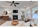 Cozy living room featuring a fireplace, plush seating, and a view into the bedroom at 5650 Bergeson Ways, Cumming, GA 30028