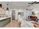 Open-concept living room and kitchen area with stainless steel appliances and modern decor at 5650 Bergeson Ways, Cumming, GA 30028