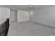 Spacious loft area with gray carpet, neutral paint, and a staircase railing at 5650 Bergeson Ways, Cumming, GA 30028