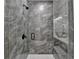 Elegant shower features grey tile, black trim, and a frameless glass door at 5650 Bergeson Ways, Cumming, GA 30028