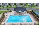 Aerial view of a sparkling community swimming pool with lounge chairs and manicured landscaping at 5650 Bergeson Ways, Cumming, GA 30028