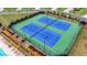 Aerial view of community tennis courts featuring well-maintained blue courts and manicured landscaping at 5650 Bergeson Ways, Cumming, GA 30028