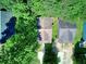 An aerial view reveals the home's placement amidst lush greenery, offering both privacy and a neighborhood feel at 70 Gardenia Nw Dr, Atlanta, GA 30314