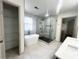 Modern bathroom featuring a freestanding tub, glass shower, and neutral tile at 70 Gardenia Nw Dr, Atlanta, GA 30314