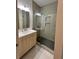 A well-lit bathroom with a glass shower and a light wood vanity cabinet at 70 Gardenia Nw Dr, Atlanta, GA 30314