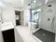 Modern bathroom featuring a glass-enclosed shower, soaking tub, and double vanity at 70 Gardenia Nw Dr, Atlanta, GA 30314