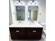 Bathroom with double vanity sinks, large mirrors, and modern lighting fixtures at 70 Gardenia Nw Dr, Atlanta, GA 30314