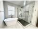 Bright bathroom with a modern soaking tub and frameless glass shower at 70 Gardenia Nw Dr, Atlanta, GA 30314