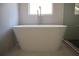 Close-up of a modern soaking tub in a well-lit bathroom at 70 Gardenia Nw Dr, Atlanta, GA 30314