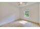 Bright bedroom with hardwood floors, a ceiling fan, and a window overlooking the backyard at 70 Gardenia Nw Dr, Atlanta, GA 30314