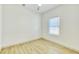 Bright bedroom with hardwood floors, a ceiling fan, and a window overlooking the backyard at 70 Gardenia Nw Dr, Atlanta, GA 30314
