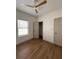A bright bedroom is shown, featuring a ceiling fan, a window, wood floors and closet at 70 Gardenia Nw Dr, Atlanta, GA 30314