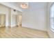 Large bonus room with light wood-look flooring, a vaulted ceiling and a large window at 70 Gardenia Nw Dr, Atlanta, GA 30314
