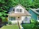 Charming home with a well-maintained lawn and complemented by lush surrounding trees at 70 Gardenia Nw Dr, Atlanta, GA 30314