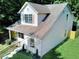This two-story home features a cozy front porch and well-manicured lawn, blending charm with tranquility at 70 Gardenia Nw Dr, Atlanta, GA 30314