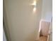 Hallway with a white door at the bottom of the stairs with a light fixture on the wall at 70 Gardenia Nw Dr, Atlanta, GA 30314