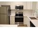 Stainless steel appliances compliment the clean, white countertops in this kitchen at 70 Gardenia Nw Dr, Atlanta, GA 30314