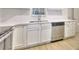 Modern kitchen featuring white cabinets, stainless steel appliances, and light countertops at 70 Gardenia Nw Dr, Atlanta, GA 30314