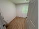An open room with light wooden floors and a bright window for natural light at 70 Gardenia Nw Dr, Atlanta, GA 30314