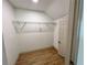 Empty walk-in closet with hardwood floors and ample hanging storage space at 70 Gardenia Nw Dr, Atlanta, GA 30314