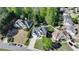 Aerial view of the home in a neighborhood with manicured lawns and mature trees at 5420 Avonshire Ln, Cumming, GA 30040