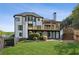 Landscaped backyard with deck, patio, green grass and a fence, great for outdoor living at 5420 Avonshire Ln, Cumming, GA 30040