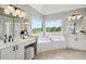 Lavish bathroom with double sink vanity, soaking tub, and natural light at 5420 Avonshire Ln, Cumming, GA 30040