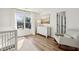 Comfortable Bedroom with wood floors, window, white furniture, and neutral color palette at 5420 Avonshire Ln, Cumming, GA 30040