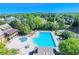 Aerial view of the community pool with abundant lounge chairs, a pool, and a view of the tennis courts at 5420 Avonshire Ln, Cumming, GA 30040