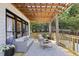 Relax on this beautiful deck featuring comfortable seating and a stylish pergola at 5420 Avonshire Ln, Cumming, GA 30040