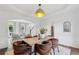 Open-concept dining room flows to the living room, filled with natural light and has sophisticated decor at 5420 Avonshire Ln, Cumming, GA 30040