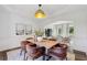 Well-lit dining room connects to living spaces, showcasing an artful aesthetic and stylish furniture at 5420 Avonshire Ln, Cumming, GA 30040