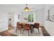 Elegant dining room with modern lighting, wainscoting detail, and stylish chairs, ideal for entertaining guests at 5420 Avonshire Ln, Cumming, GA 30040