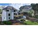 Backyard showcasing a spacious home with a deck, patio, and landscaped yard at 5420 Avonshire Ln, Cumming, GA 30040